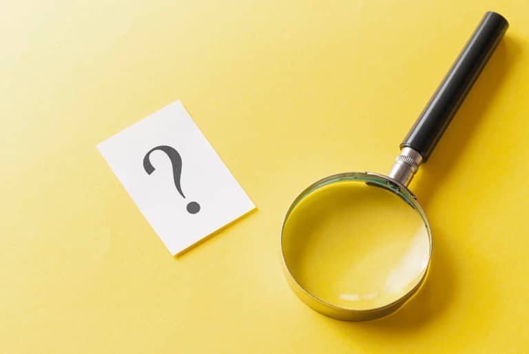 Magnifying glass with printed question mark